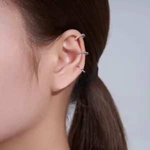 Macro detail of three S925 silver moissanite C-shaped ear cuffs worn on a model's ear