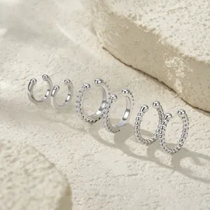 Macro view of S925 sterling silver C-shaped ear cuffs featuring moissanite and twisted designs