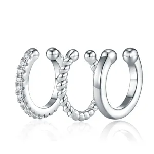 Detailed view of three silver S925 moissanite ear cuffs featuring varied textures