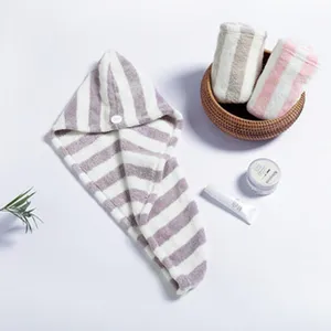 Detail shot of purple striped coral fleece hair drying cap with button, soft and absorbent.