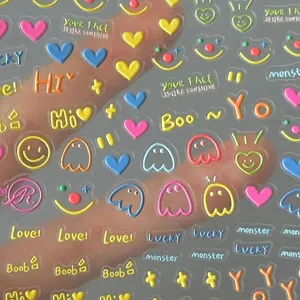 Close-up detail of 3D puffy cute smiley face and ghost nail stickers with transparent base design.