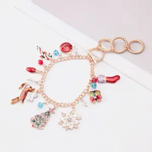Detail shot of festive Christmas charm bracelet with snowflake and reindeer enamel pendants