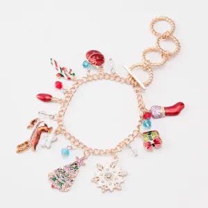 Detailed view of a gold-finish Christmas charm bracelet featuring enamel snowflake and reindeer