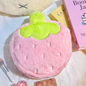 Macro view of a cute plush pink strawberry makeup bag showing its soft faux fur texture
