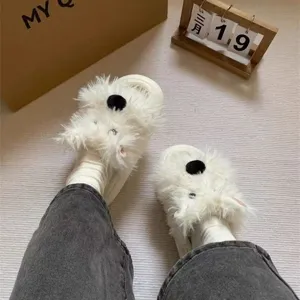 Close-up detail view of fluffy cute dog slippers with soft plush for cozy home wear.