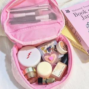 Detailed view of large capacity pink fuzzy cosmetic bag showing internal mesh pocket