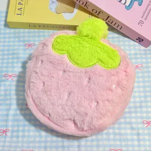 Adorable plush strawberry makeup bag with soft fluffy texture and vibrant pink color