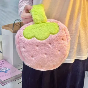 Close-up detail of a cute pink strawberry-shaped plush makeup bag with soft fuzzy texture