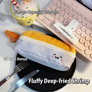 Plush fried shrimp tempura pencil case with cute embroidered face in lifestyle setting