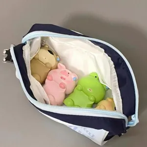 Large capacity blue and white cat pencil case with cute animal figures shown inside