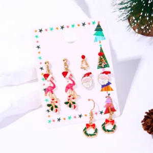 Detail of Christmas enamel earring set featuring Santa, flamingo and festive motifs.