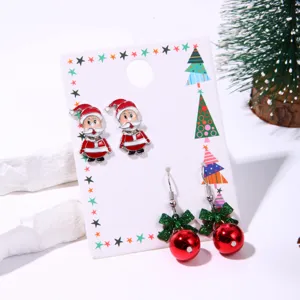 Close-up of Christmas earring set with Santa studs and red bell hook earrings