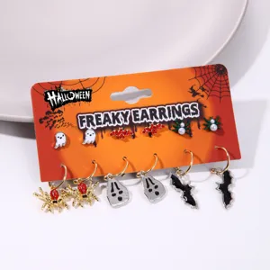 Macro view of Halloween earring collection with spider, ghost, and bat charms on display card