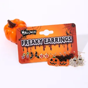 Macro shot of a Halloween themed earring set with pumpkin, ghost, and bat stud designs