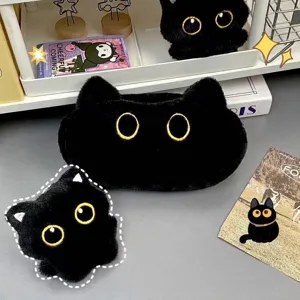 Close-up of fluffy black cat plush pencil case with large yellow eyes