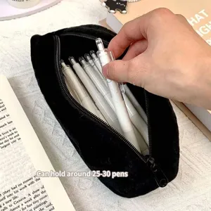 Cute black plush cat pencil case with large capacity shown holding several white pens