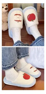 Detailed view of cute plush cotton slippers featuring red apple embroidery and soft fuzzy lining.