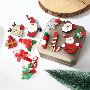 Detail view of festive Christmas hair clips featuring Santa Claus, reindeer and snowflakes