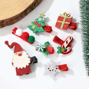 Detailed view of festive Christmas hair clips featuring Santa Claus and snowflake designs