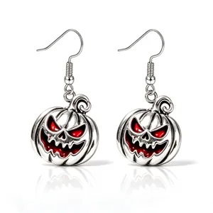 Close-up of retro silver scary pumpkin drop earrings with red enamel details