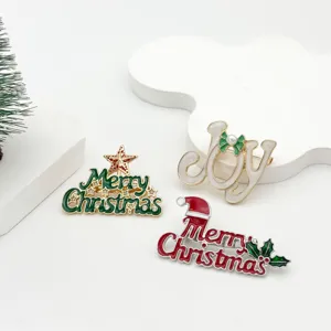 Close-up of enamel Christmas brooches with festive Merry Christmas and Joy designs