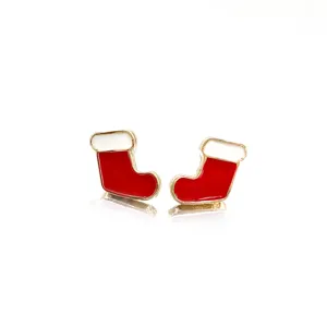 Detail view of red and white enamel Christmas stocking stud earrings with gold trim