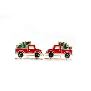 Detailed macro view of red Christmas truck enamel stud earrings featuring festive tree design.