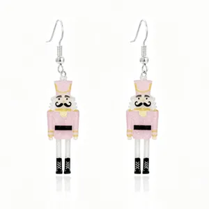 Detailed view of pink nutcracker soldier earrings with glitter finish for Christmas.