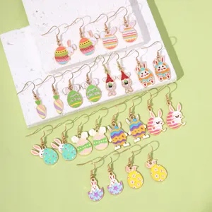 Multiple pairs of colorful Easter earrings with cute bunny and egg designs on white block