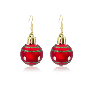 Detailed view of red Christmas ball ornament earrings with green and white glitter