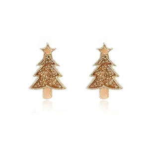 Detailed macro view of sparkling Christmas tree stud earrings with gold glitter finish