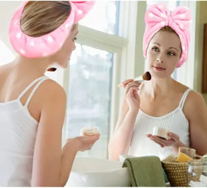 Pink polka dot fluffy bow headband, soft plush spa makeup hair band for daily face washing detail.