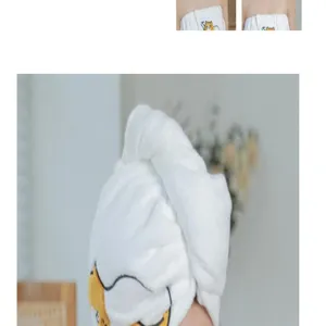 Cute embroidered coral fleece hair drying towel cap for women, soft absorbent bath cap detail.
