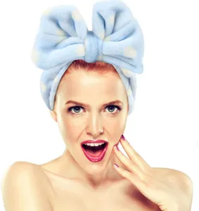 Soft flannel makeup headband with large polka dot bow for daily facial washing and skincare.
