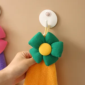 Hanging coral velvet hand towel with cute cartoon flower design, highly absorbent and soft.