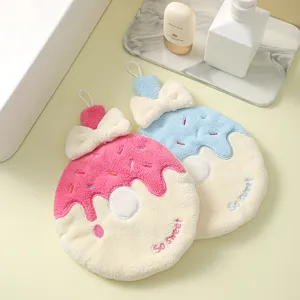 Close-up view of two cute donut-shaped coral fleece hand towels with bow detailing and hanging loops