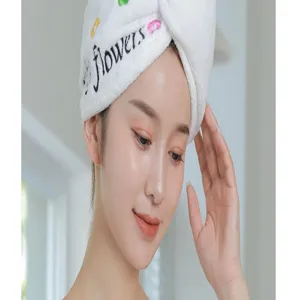 Soft coral fleece dry hair cap detail view, ultra-absorbent bath towel wrap for fast hair drying.