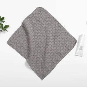 Grey waffle weave kitchen dish towel, highly absorbent small cleaning cloth for home use.