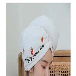 Close-up detail of white coral fleece dry hair cap with cute sweet strawberry print.