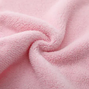 Macro texture view of a soft pink microfiber makeup remover towel for face cleansing