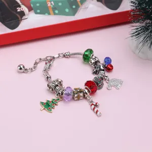 Primer plano de una pulsera de dijes navideños con árbol de Navidad y bastón de caramelo