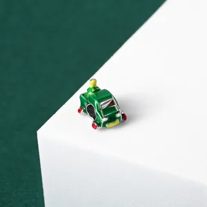Detailed macro shot of a green enamel Christmas truck charm for DIY jewelry bracelets