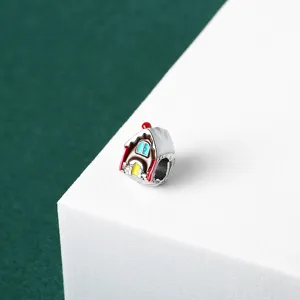 Detail view of a Christmas gingerbread house charm bead with colorful enamel for DIY jewelry