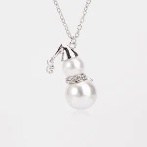 Close-up of cute snowman pendant necklace featuring two pearls and sparkling rhinestones