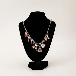 Festive Christmas charm necklace featuring snowflake tree and reindeer enamel pendants