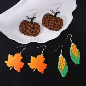 Detailed view of Thanksgiving acrylic earrings with pumpkin, maple leaf, and corn designs.