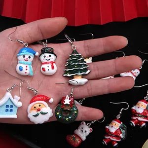 Hand-held variety of cute cartoon resin Christmas earrings including Santa and Snowman.