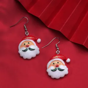 Close-up of sweet cartoon Santa Claus resin drop earrings on festive red background