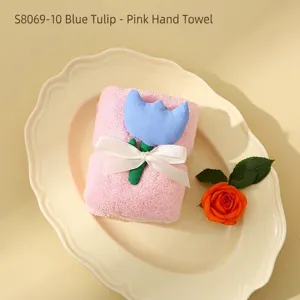 Elegant pink coral fleece square towel decorated with a 3D blue tulip and white ribbon bow.
