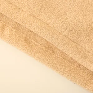 Close-up macro of camel winter fleece neck gaiter with soft thick warm texture